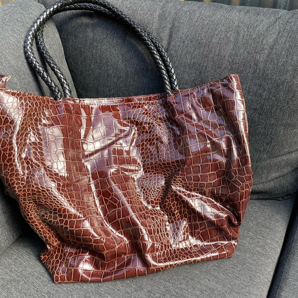 Brown faux leather tote bag with black interior liner